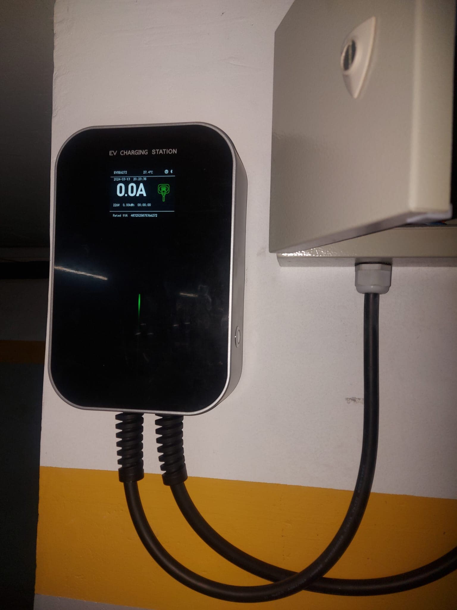 Wallbox with integrated cable installed in a building garage